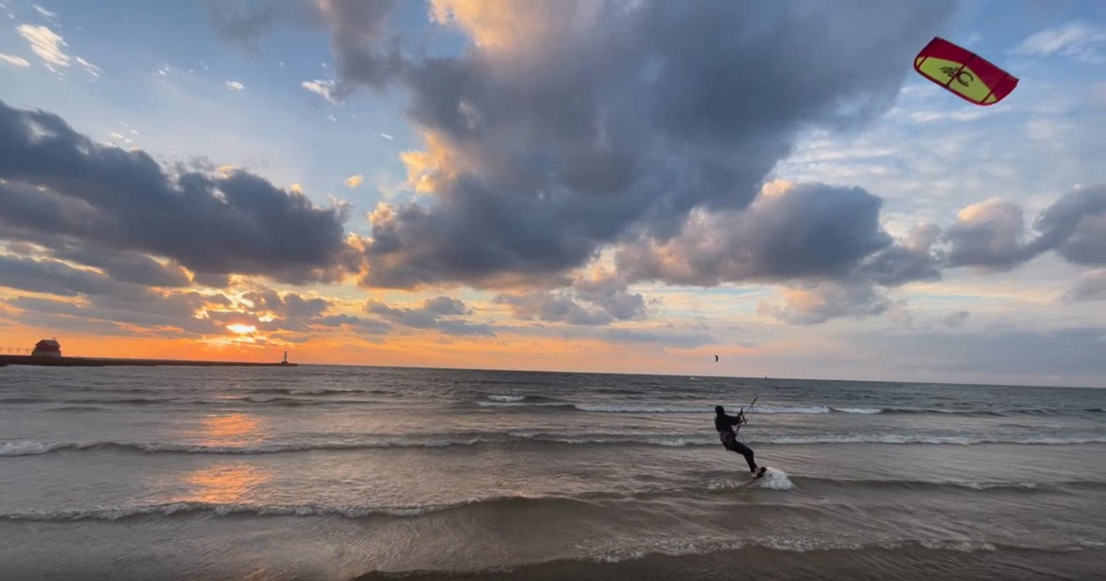Kiteboarder riding at sunset just north of the Grand Haven pier, Lake Michigan